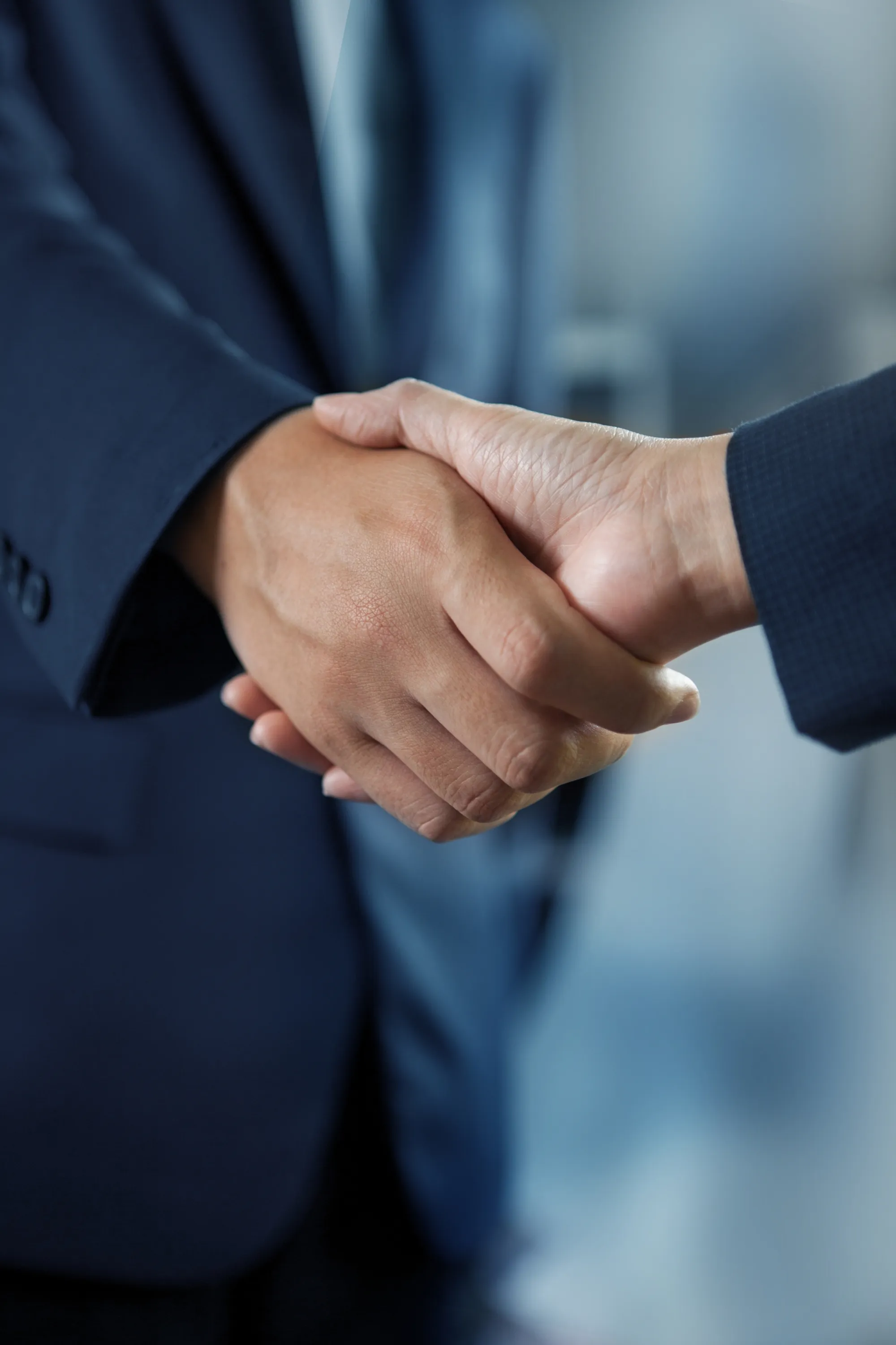 Two people shaking hands after closing a deal